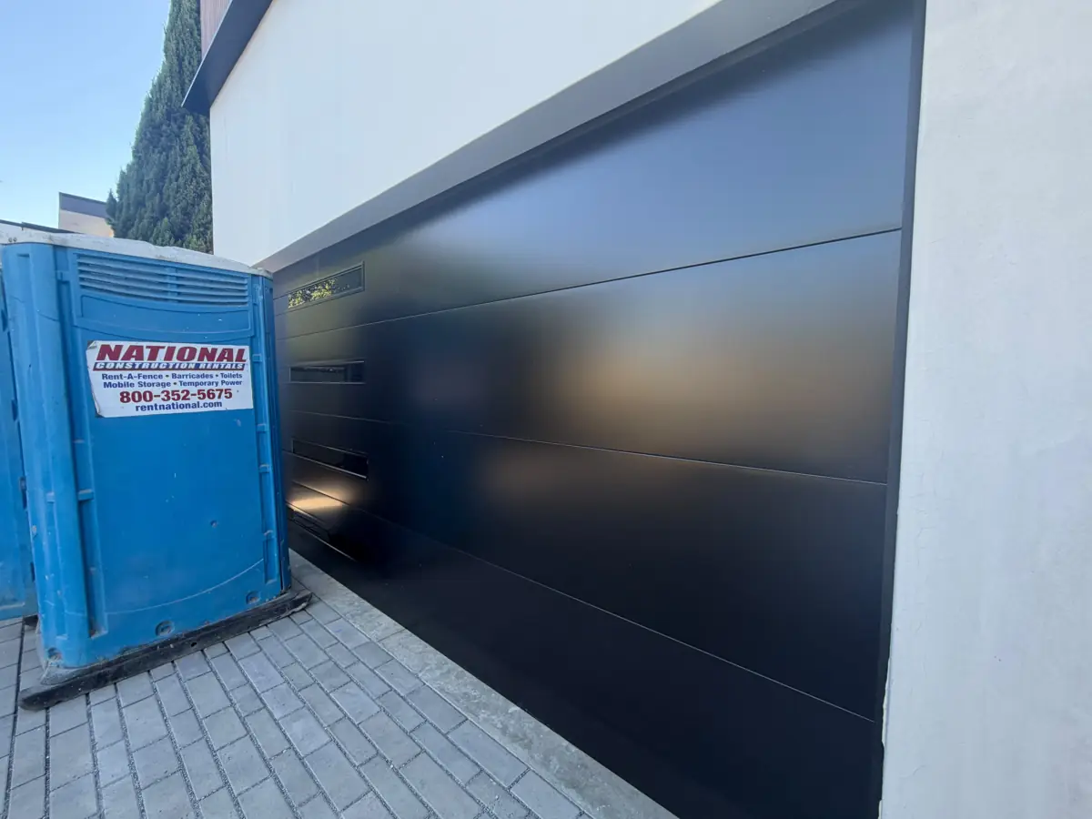 Flush black modern garage door on a new build