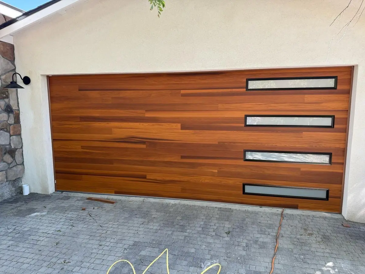 Wood-grain modern garage door with frosted window strips
