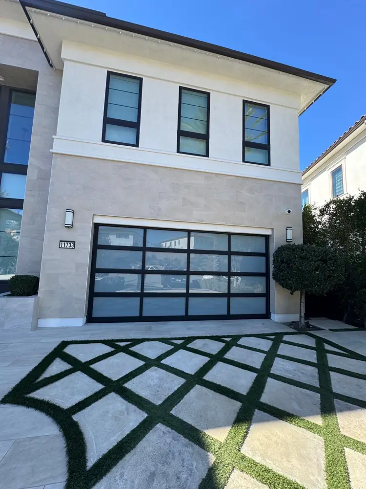 Black glass garage door on a modern two-story home