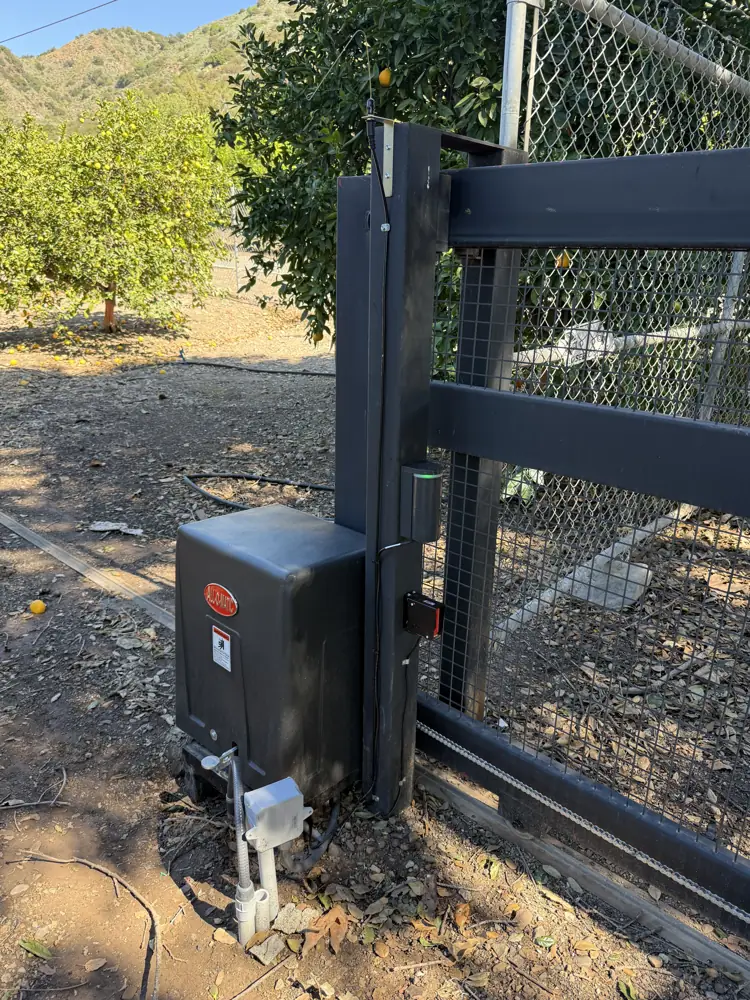 Sliding gate motor installed on a black steel gate