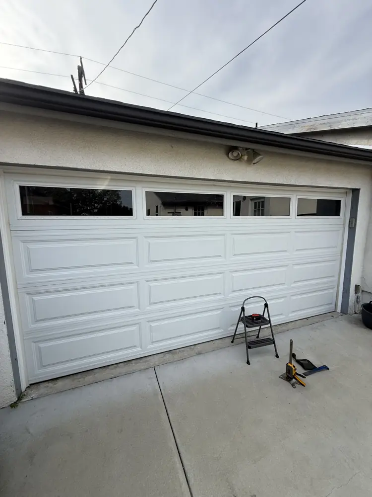 White garage door with a top row of windows