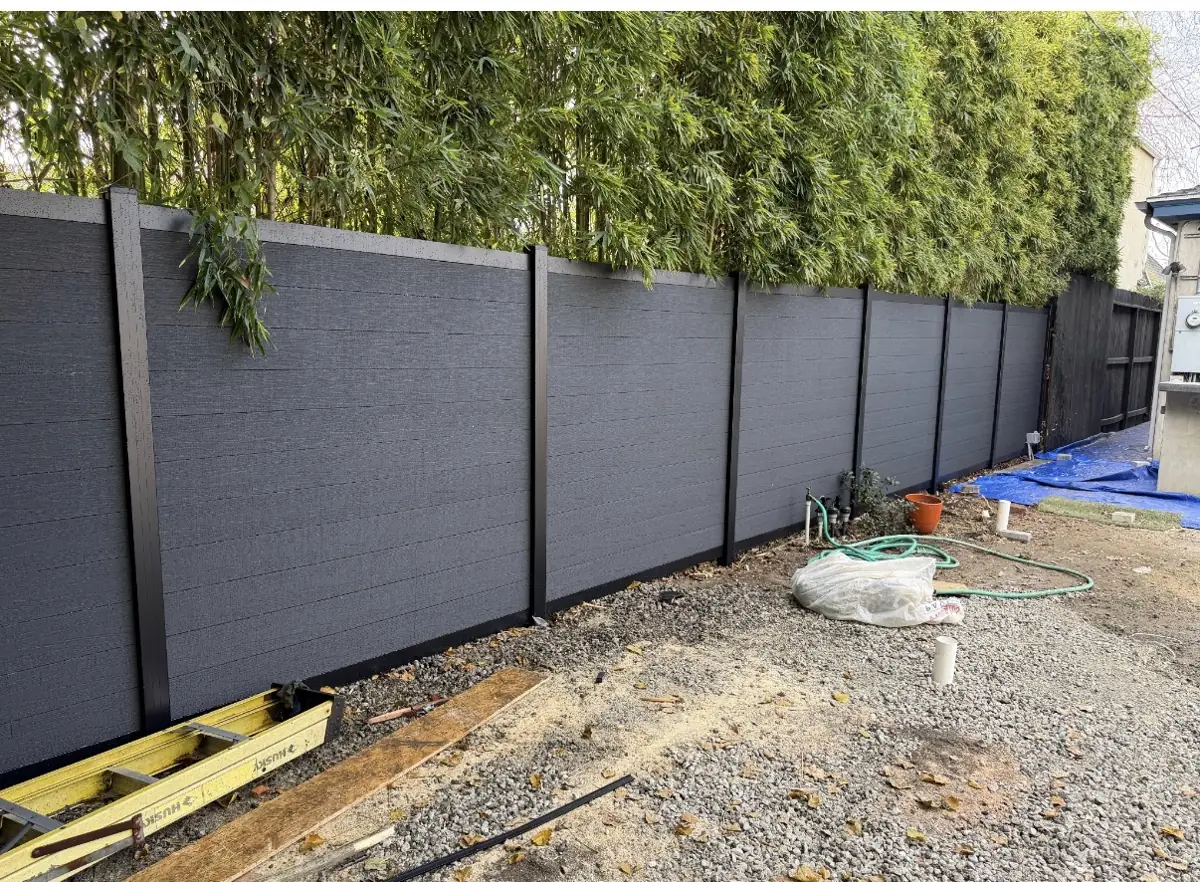 Dark privacy fence panels along a backyard