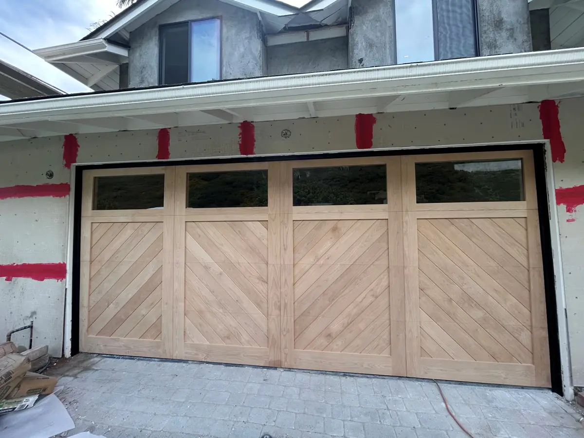 Natural wood carriage-house garage door with windows