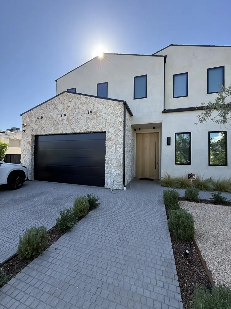 Black flush garage door on a new modern home