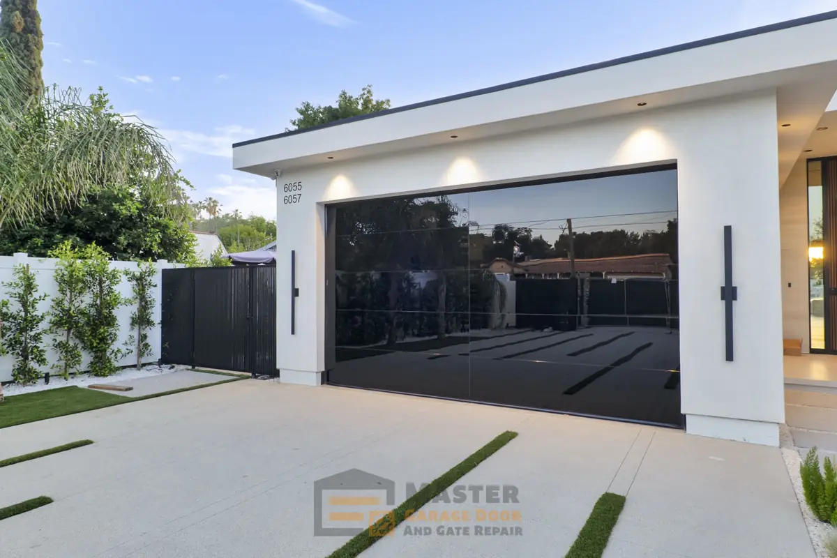 Black glass garage door on a contemporary white home