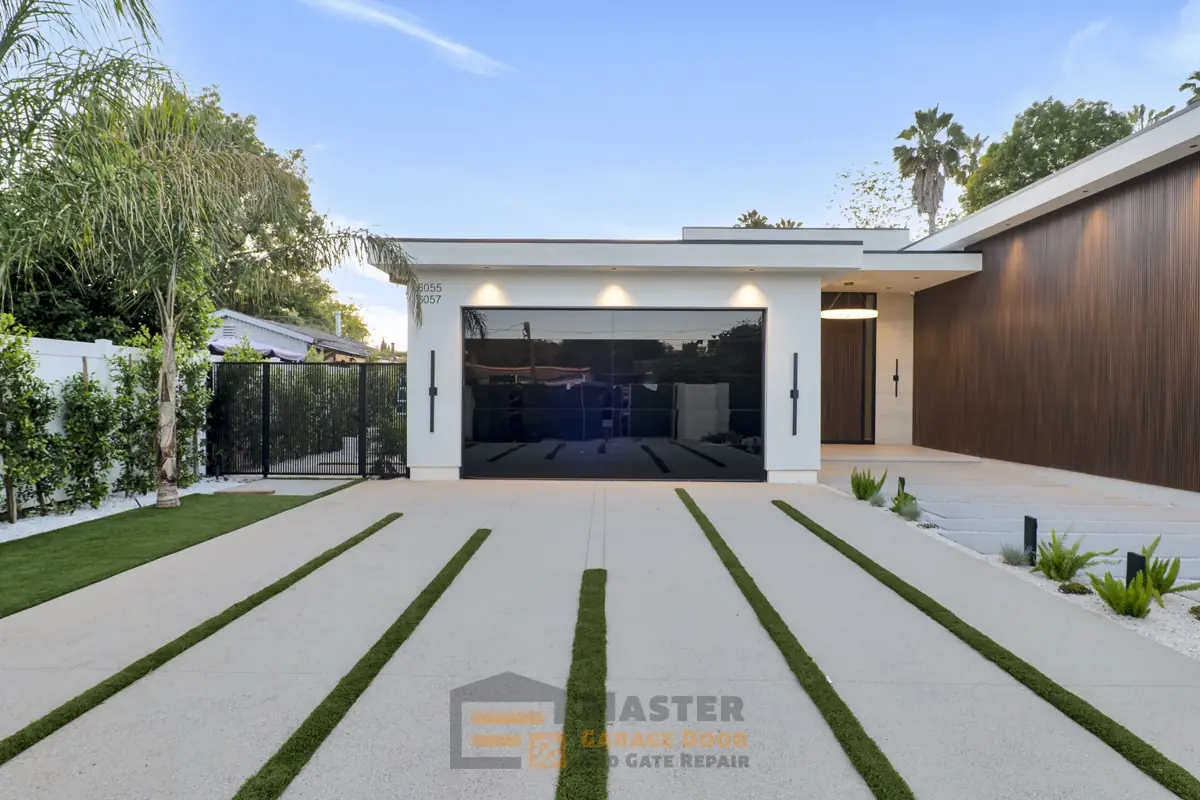 Contemporary home with black glass garage door and wood siding