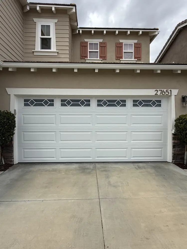 White garage door with decorative window inserts