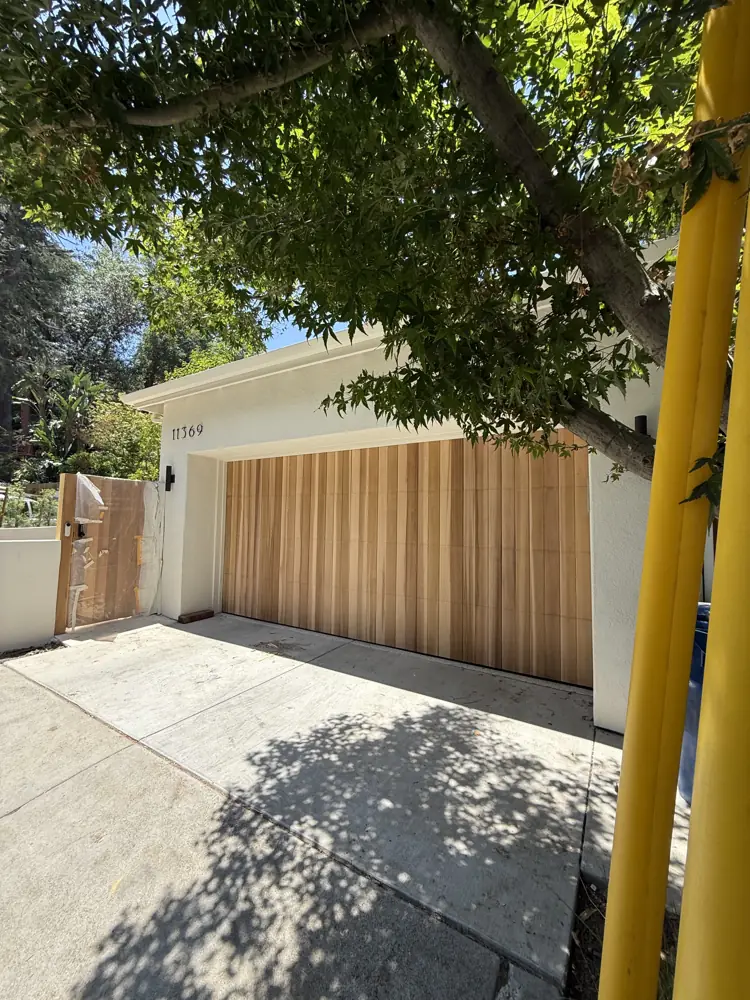Natural wood plank garage door with matching side gate