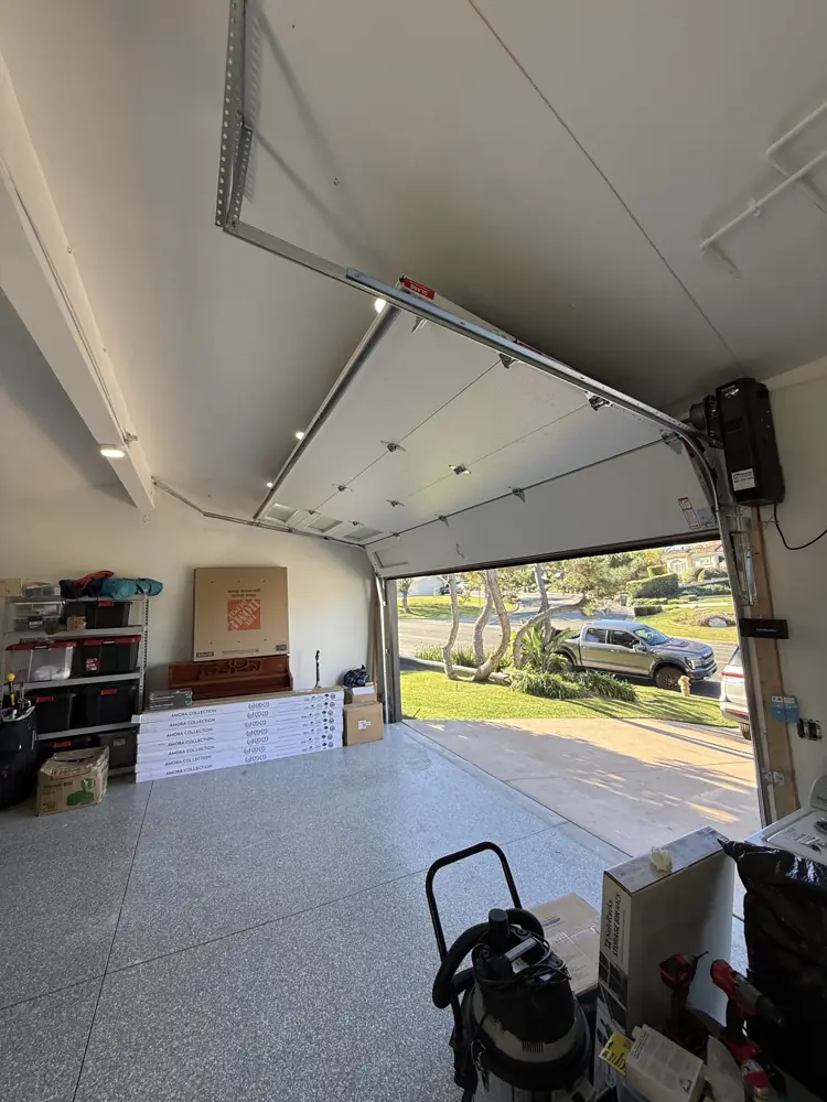New garage door opener and tracks inside a garage
