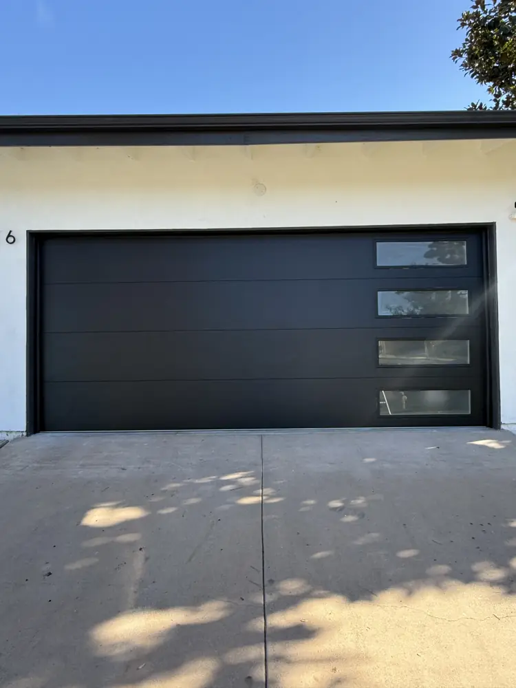Black flush garage door with side window strips