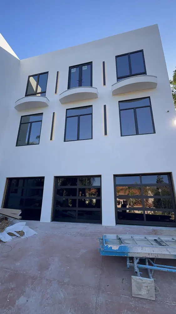 Glass garage doors on a modern multi-story home