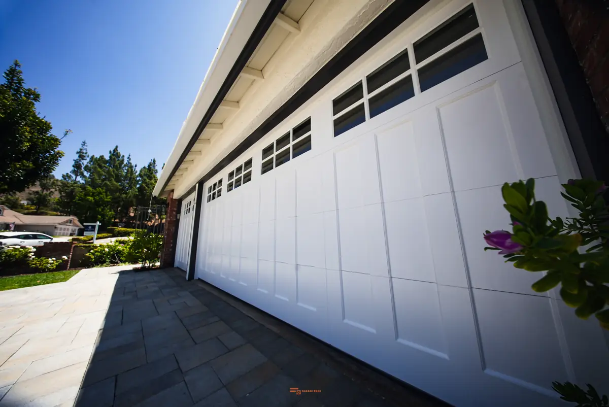 Long run of white carriage-house garage doors
