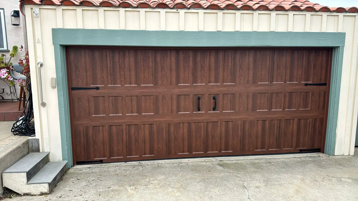 Wood-grain steel garage door with black handles