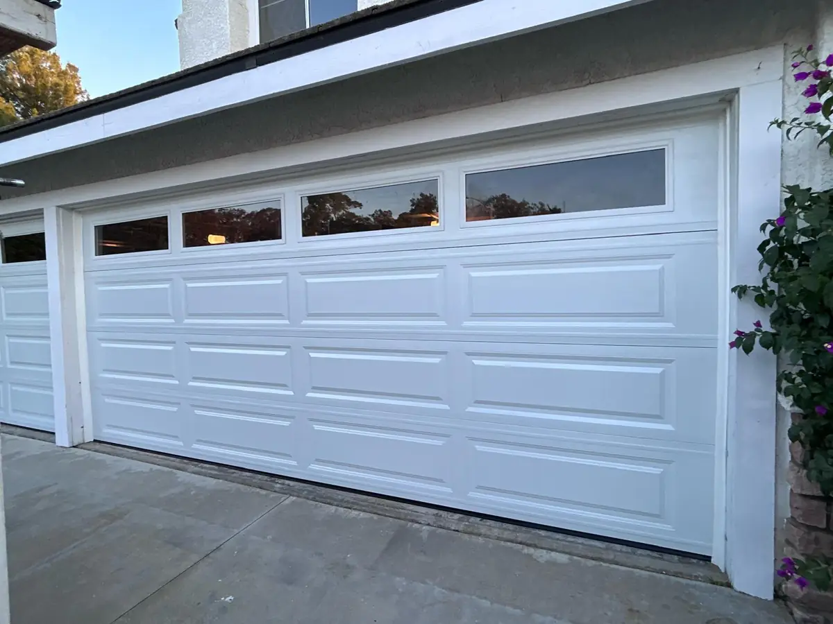 White raised-panel garage door with windows