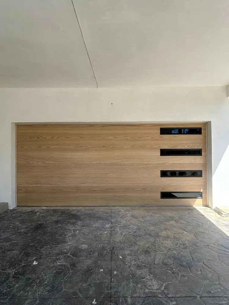 Wood-look modern garage door with black window strips