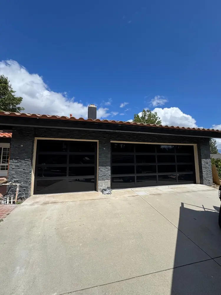 Black full-view glass garage doors
