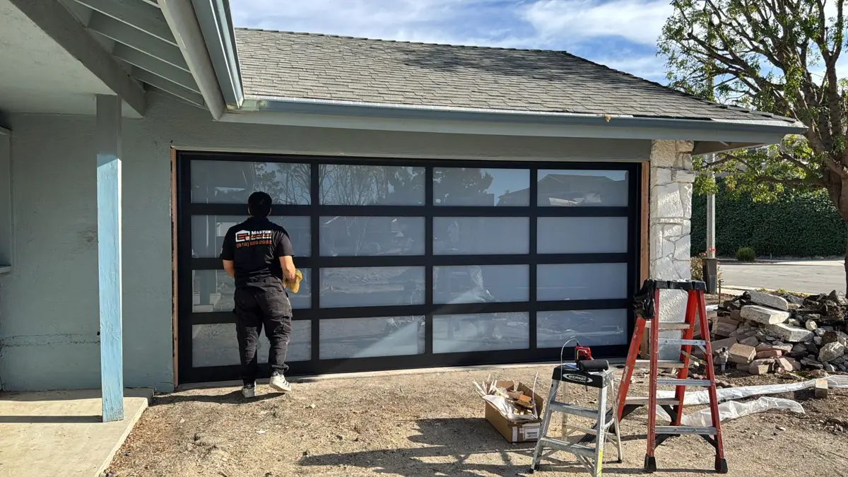 Technician installing a full-view glass garage door
